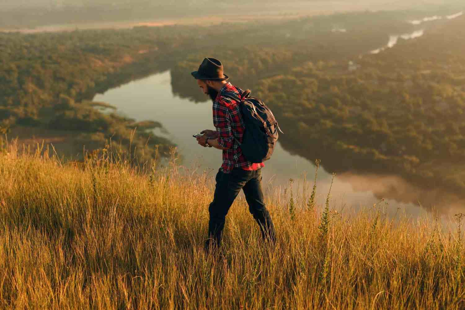 Traveler using smartphone in nature