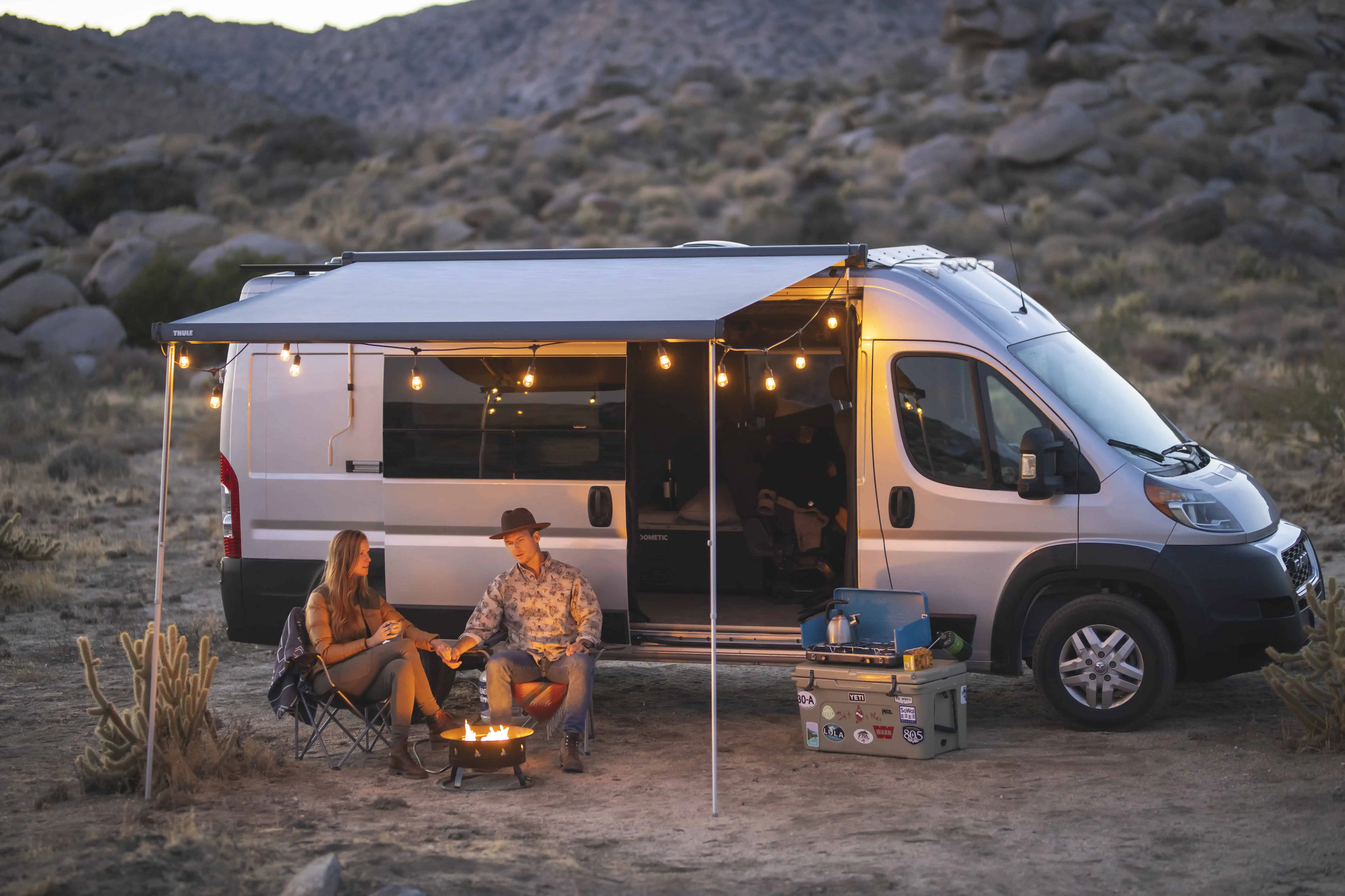 two people waiting outside their campervan with proper light.